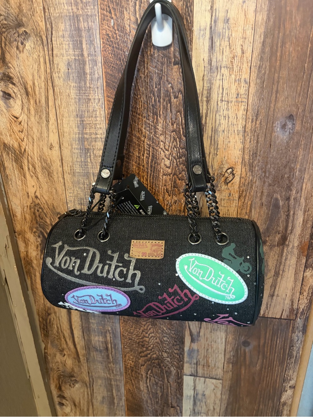Von Dutch Black Barrel Shoulder Bag with Multicolor Logo Patches